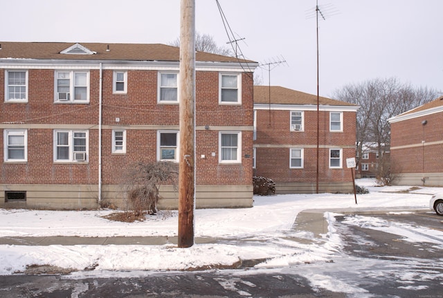 view of snow covered rear of property