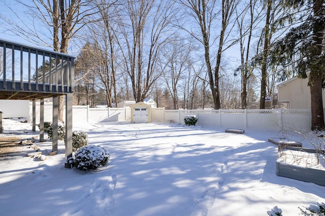 snowy yard with a shed