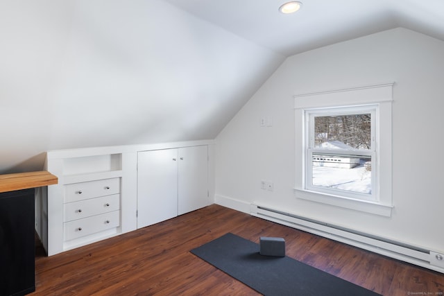 additional living space with a baseboard radiator, lofted ceiling, and dark hardwood / wood-style floors