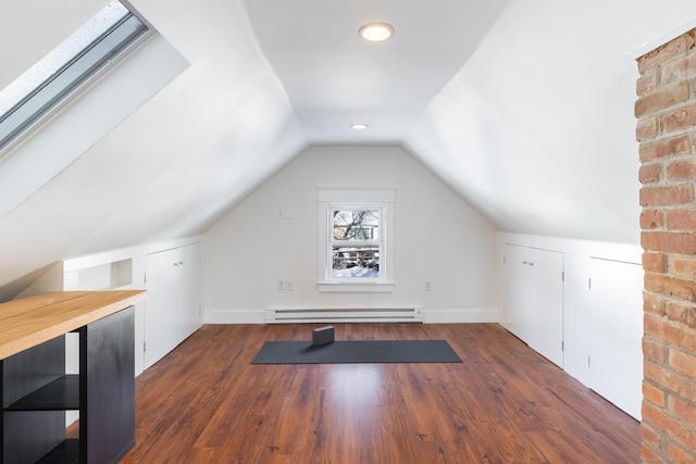 bonus room featuring lofted ceiling, dark wood-type flooring, and a baseboard radiator