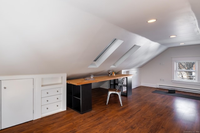 unfurnished office with dark hardwood / wood-style flooring, vaulted ceiling with skylight, and a baseboard heating unit