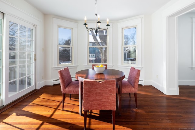 dining space with dark hardwood / wood-style flooring, a baseboard radiator, a healthy amount of sunlight, and an inviting chandelier