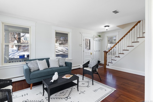 living room featuring baseboard heating and wood-type flooring