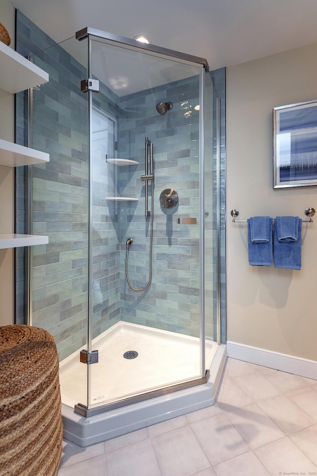 bathroom featuring a shower with shower door and tile patterned floors