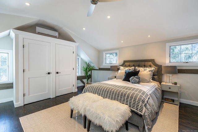 bedroom with multiple windows, ceiling fan, and a wall mounted AC