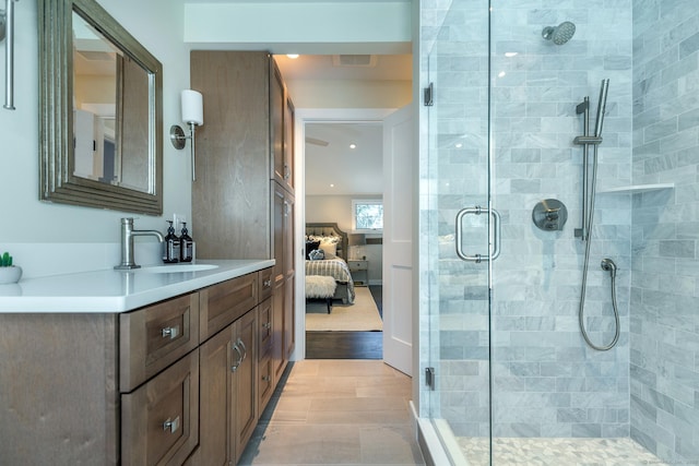 bathroom with vanity and a shower with shower door