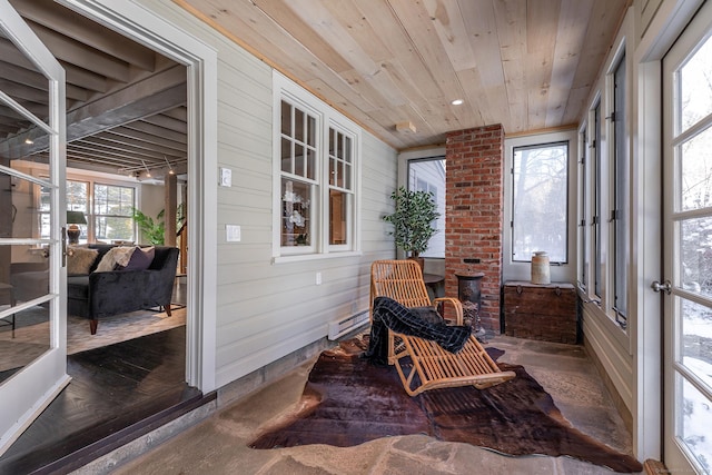 sunroom / solarium featuring wooden ceiling and baseboard heating