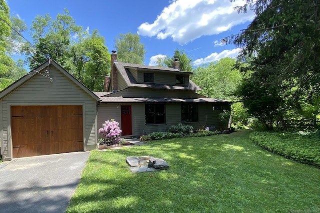 view of front of house with a garage and a front yard