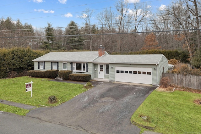 ranch-style house with a garage and a front yard