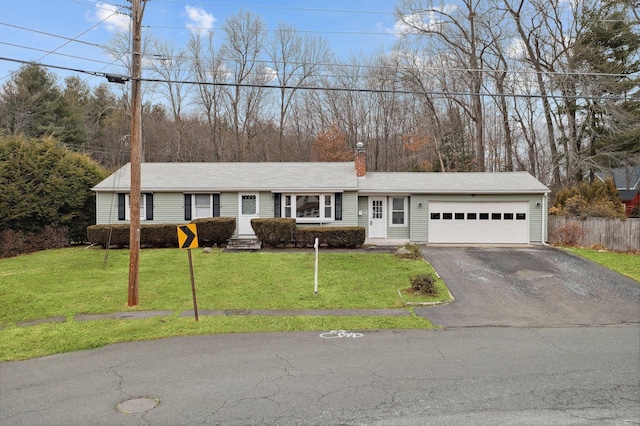 ranch-style house with a garage and a front lawn