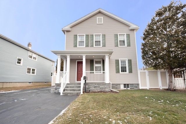 view of front of property with a front yard and covered porch