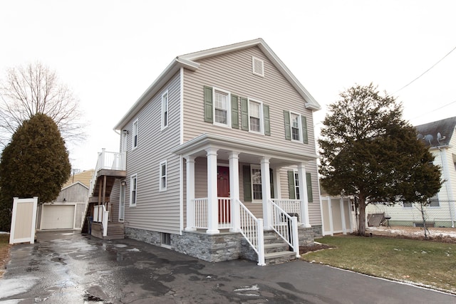 view of front of property with a garage, an outdoor structure, and a front yard