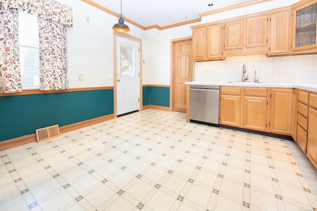 kitchen featuring pendant lighting, sink, crown molding, dishwasher, and tasteful backsplash