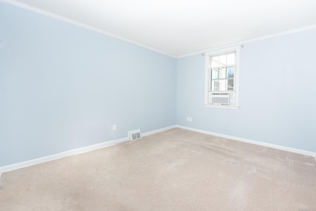 carpeted spare room featuring crown molding and cooling unit