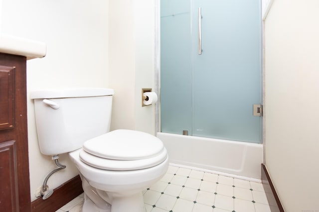 bathroom featuring shower / bath combination with glass door and toilet