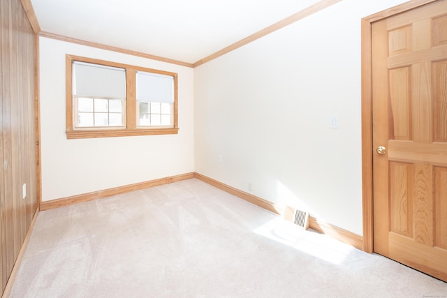 carpeted empty room with crown molding