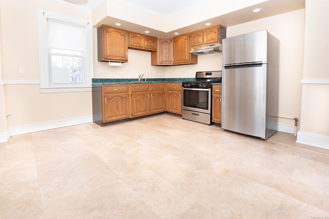 kitchen featuring crown molding, stainless steel appliances, and sink