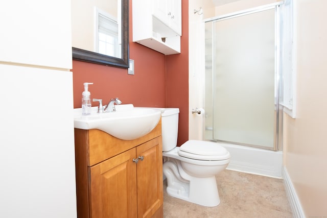 full bathroom featuring vanity, enclosed tub / shower combo, and toilet