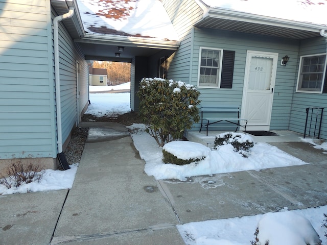 view of snow covered property entrance