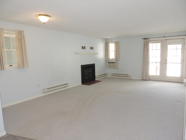 unfurnished living room featuring a baseboard radiator, carpet floors, and french doors