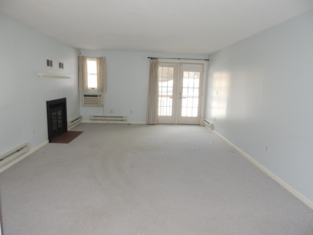 unfurnished living room featuring french doors, carpet, and a baseboard heating unit