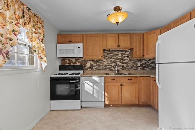 kitchen featuring sink, tasteful backsplash, and white appliances