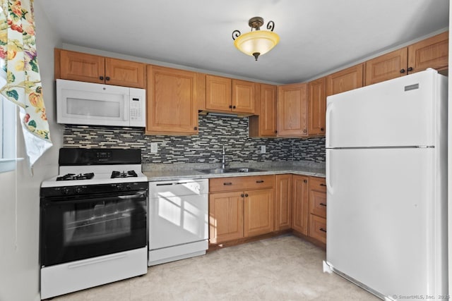 kitchen with decorative backsplash, sink, and white appliances