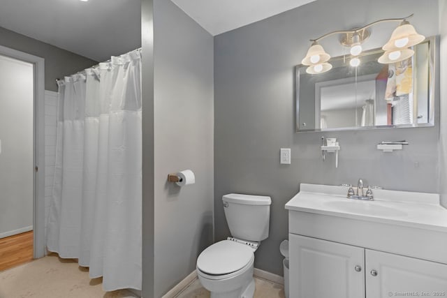 bathroom featuring toilet, a shower with shower curtain, and vanity