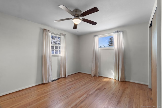 spare room featuring ceiling fan, plenty of natural light, and light hardwood / wood-style floors