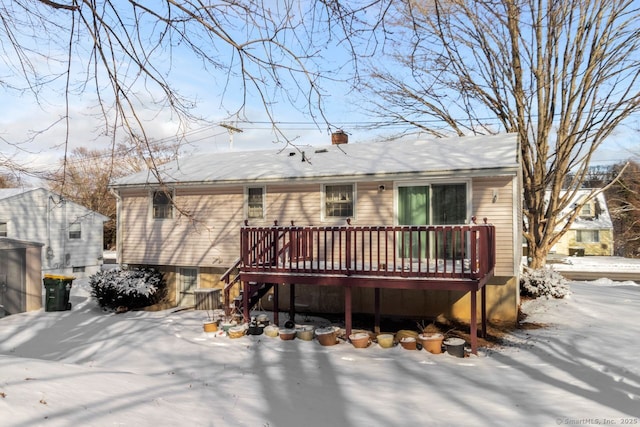 snow covered property with a deck