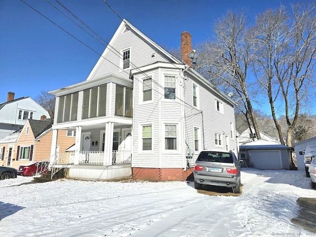 view of front of property featuring covered porch and a garage