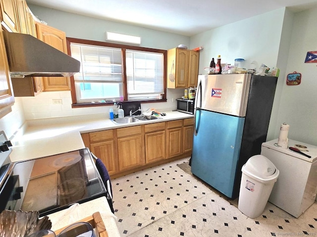 kitchen featuring sink, appliances with stainless steel finishes, and range hood