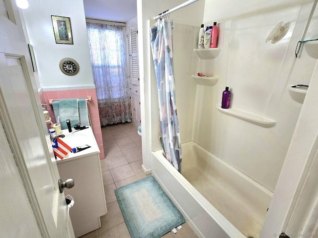 bathroom featuring tile walls, vanity, shower / bath combo, and tile patterned flooring