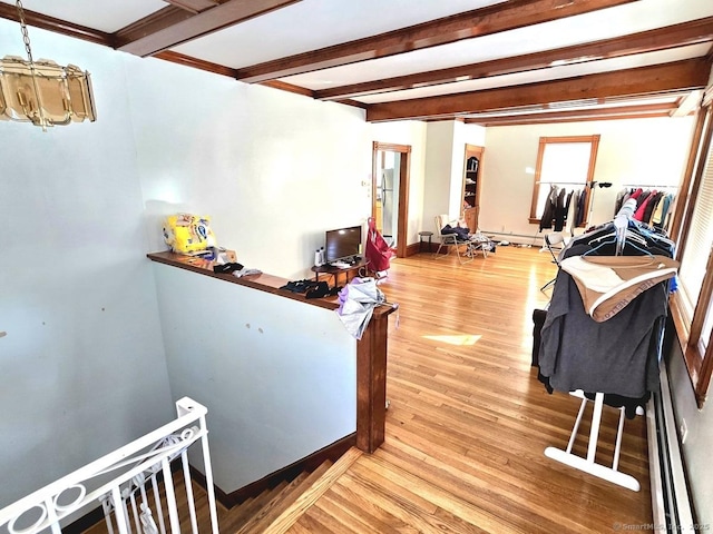 interior space with beam ceiling and hardwood / wood-style floors