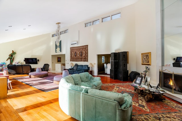 living room featuring a high ceiling and hardwood / wood-style flooring