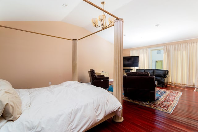 bedroom featuring dark hardwood / wood-style flooring, lofted ceiling, and a chandelier