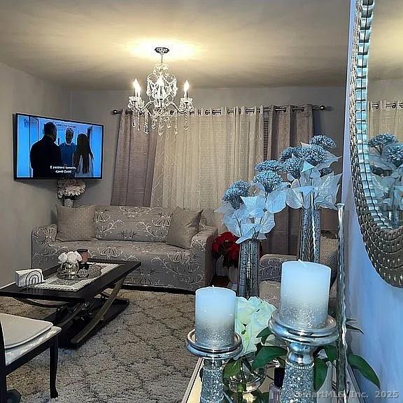 living room featuring a notable chandelier