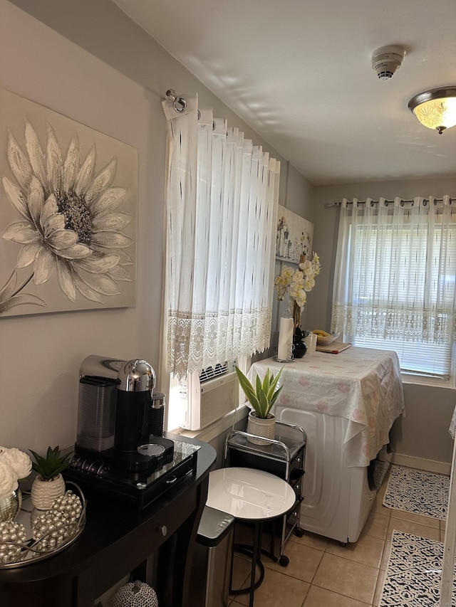 bedroom with cooling unit and light tile patterned flooring