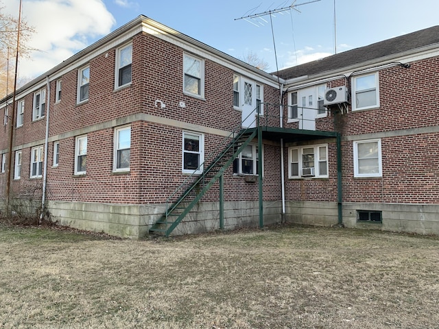 back of house featuring ac unit, cooling unit, and a lawn