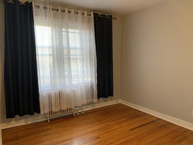 spare room with hardwood / wood-style flooring