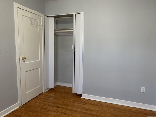 unfurnished bedroom featuring dark hardwood / wood-style floors