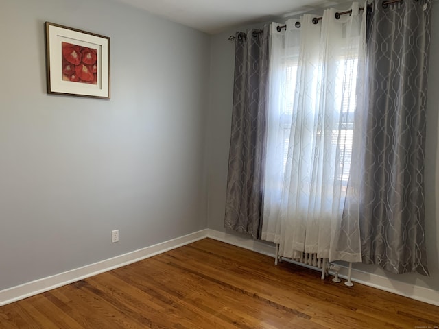 spare room with hardwood / wood-style floors