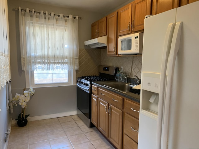 kitchen featuring light tile patterned floors, sink, white appliances, and backsplash