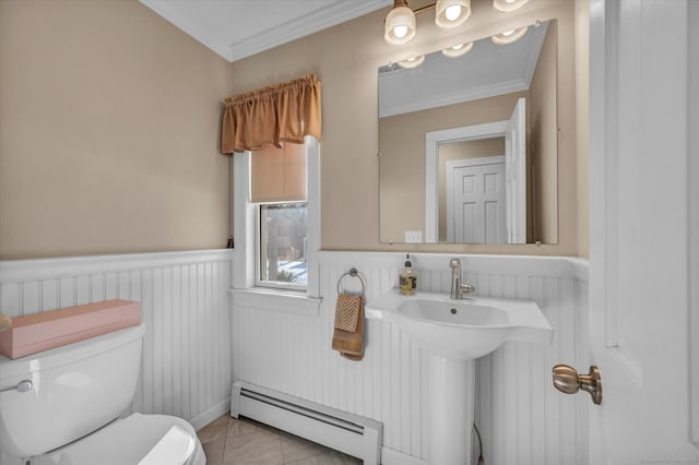 bathroom featuring baseboard heating, ornamental molding, tile patterned floors, and toilet