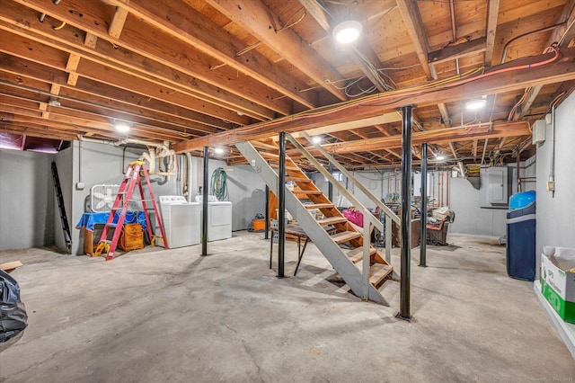 basement featuring separate washer and dryer and electric panel