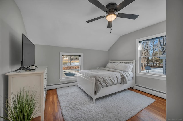 bedroom featuring baseboard heating, ceiling fan, and hardwood / wood-style flooring