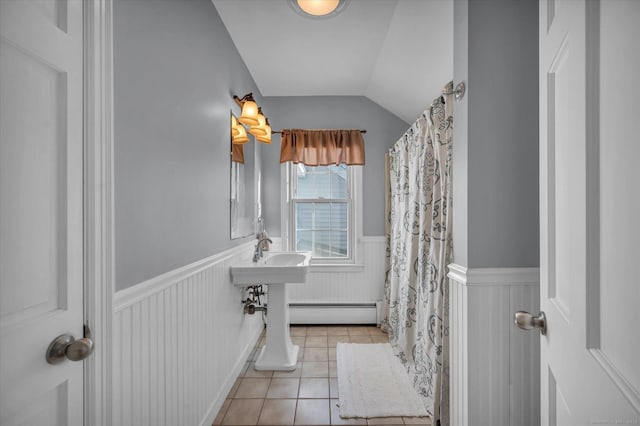 bathroom with lofted ceiling, a baseboard radiator, and tile patterned floors