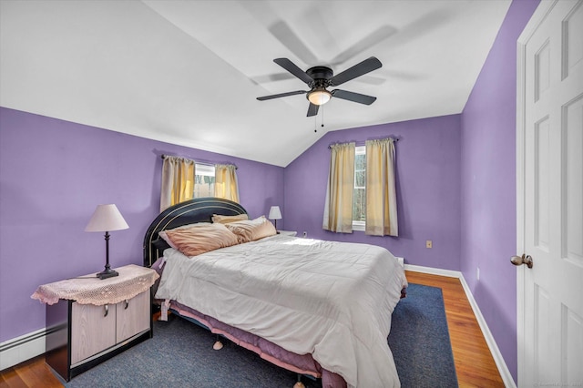 bedroom with multiple windows, lofted ceiling, hardwood / wood-style floors, and ceiling fan