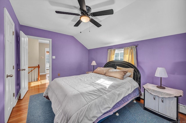 bedroom featuring lofted ceiling, hardwood / wood-style flooring, and ceiling fan