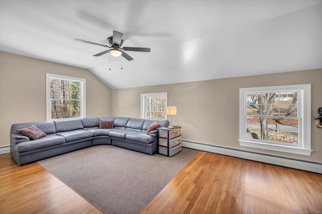 living room featuring hardwood / wood-style flooring, a baseboard radiator, vaulted ceiling, and ceiling fan